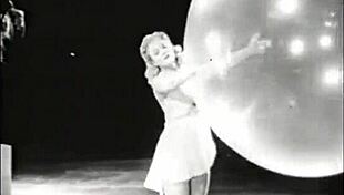 A classic blonde teen has a striptease with vintage props