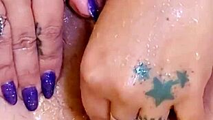 Shaved wet pussy glistens in shower with ass plug