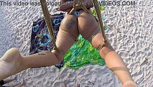 Shibari bondage on public beach with lordshibarifloripa, featuring ripped clothes, natural big tits, and voyeur fetish