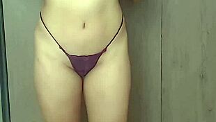 she slowly removes her red lingerie in a sensual striptease.