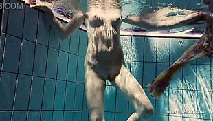 Babe floating naked in the swimming pool