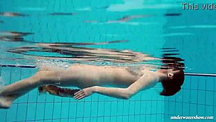 Babe floating naked in the swimming pool