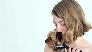 hot naked blonde cuddles her puppy in a tender moment