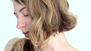 hot naked blonde cuddles her puppy in a tender moment