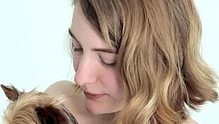 hot naked blonde cuddles her puppy in a tender moment