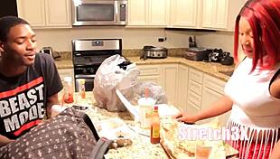 Ebony woman masturbates with thick red toy.