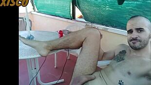 xisco gets naked outdoors, using a machine to fuck himself while neighbors watch.