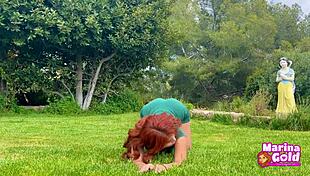 Redhead stretches flexibly in tight dress yoga outdoors, teasing with cameltoe!