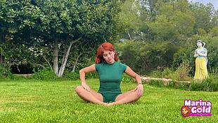 Redhead stretches flexibly in tight dress yoga outdoors, teasing with cameltoe!