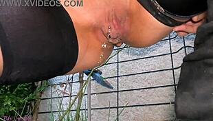 Milf La Gourmande pisses in leather skirt and stockings outdoors, caressing pierced clit after.
