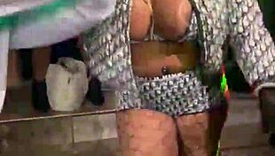 Afrocandy displaying her sizable bosom during a live show