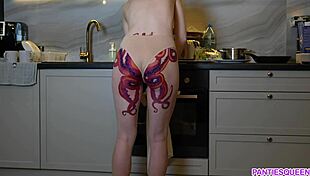 naked housewife with tattoo cooks dinner in kitchen, ignoring distractions