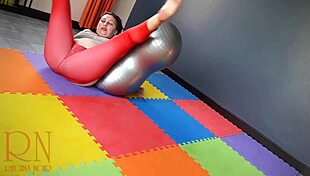 Regina Noir practices yoga in the gym in a red see through yoga leotard
