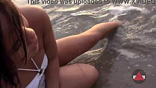 Asian model enjoys messy beach day in wet bikini
