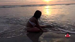 Asyalı model ıslak bikiniyle kirli plaj günü keyif alıyor.