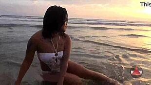 Asian model enjoys messy beach day in wet bikini