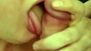 a young woman performs a blowjob on a big cock in this video