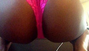 Ebony babe smokes and twerks her ass in pink panties up close.