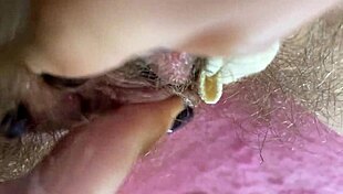 Extreme close-up of wet hairy pussy with big clit rubbing to orgasm