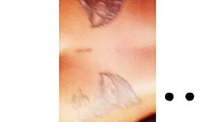 Npleasures bends over to show her new ass tattoo