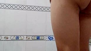 A teen bathes alone in the bathroom.