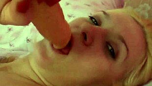 Hot blonde masturbates pussy while sucking dildo.
