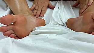 brunette applyin oil to her feet