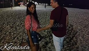 Couple caught kissing and flashing on the beach.