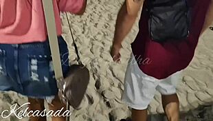 Couple caught kissing and flashing on the beach.