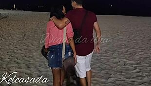 Couple caught kissing and flashing on the beach.