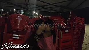 Couple caught kissing and flashing on the beach.