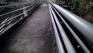 Cheating girlfriend sneaks outside for interracial fucking with a friend. They get wild on a town bridge.