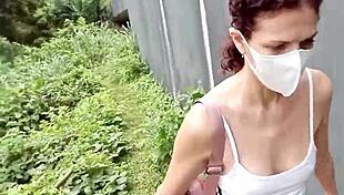 A solo masturbation scene in a public place