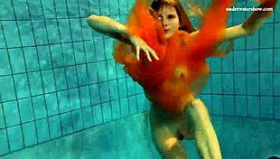 I watch Nastya strip naked and reveal her tight pussy in the pool