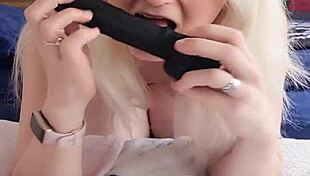 This petite blonde milf is riding that big black dildo at home.