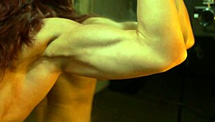 Busty Ginger Flexes Her Big Muscles in Front of the Mirror