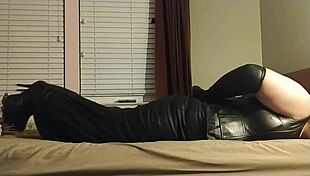 Crossdresser bound in self bondage with gagging choking in leather boots and heels