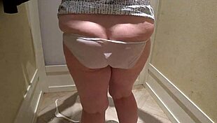 hidden camera captures a mature pawg milf in the fitting room, trying on shorts with close-up fetish views of her big ass in panties.