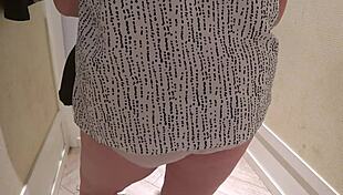 hidden camera captures a mature pawg milf in the fitting room, trying on shorts with close-up fetish views of her big ass in panties.