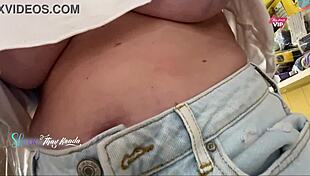 Hot wife flashes big natural tits to seller while shopping outdoors.