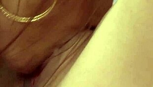 Close-up view of lesbians muff diving and tribbing, with big tits and tattoos on display during fingering.