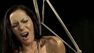 Restrained submissive punished with toys and bondage by dominant lesbian babe in garage