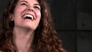 Tied-up big-titted sub punished with dildo in garage setting