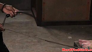 Tied-up big-titted sub punished with dildo in garage setting