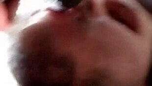 This guy eagerly sucks on a massive black cock in a casual encounter.