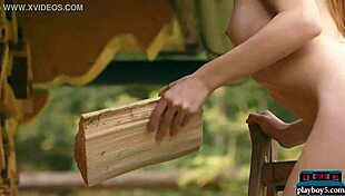 Tiny redhead teen model strips naked outdoors chopping wood