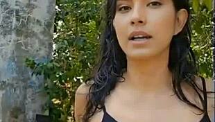 Beautiful black-haired girl gives a great presentation in the woods