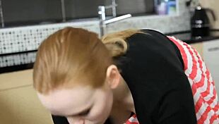 Redhead searches for keys, revealing downblouse view in kitchen