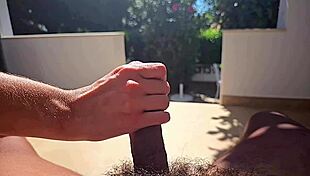 Close up and slow motion of a man giving a hand job outdoors