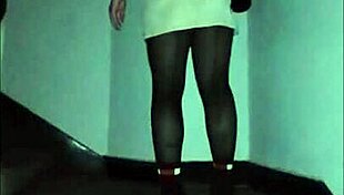 Leather catsuit clings to her legs under the miniskirt